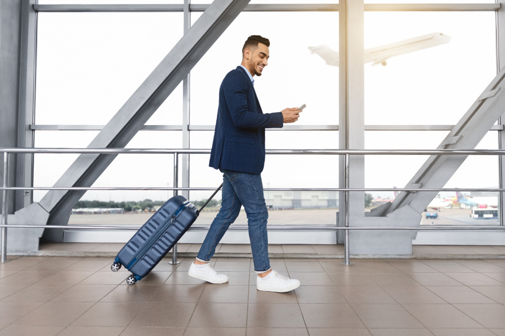 Foreign tourists using smartphones at airports