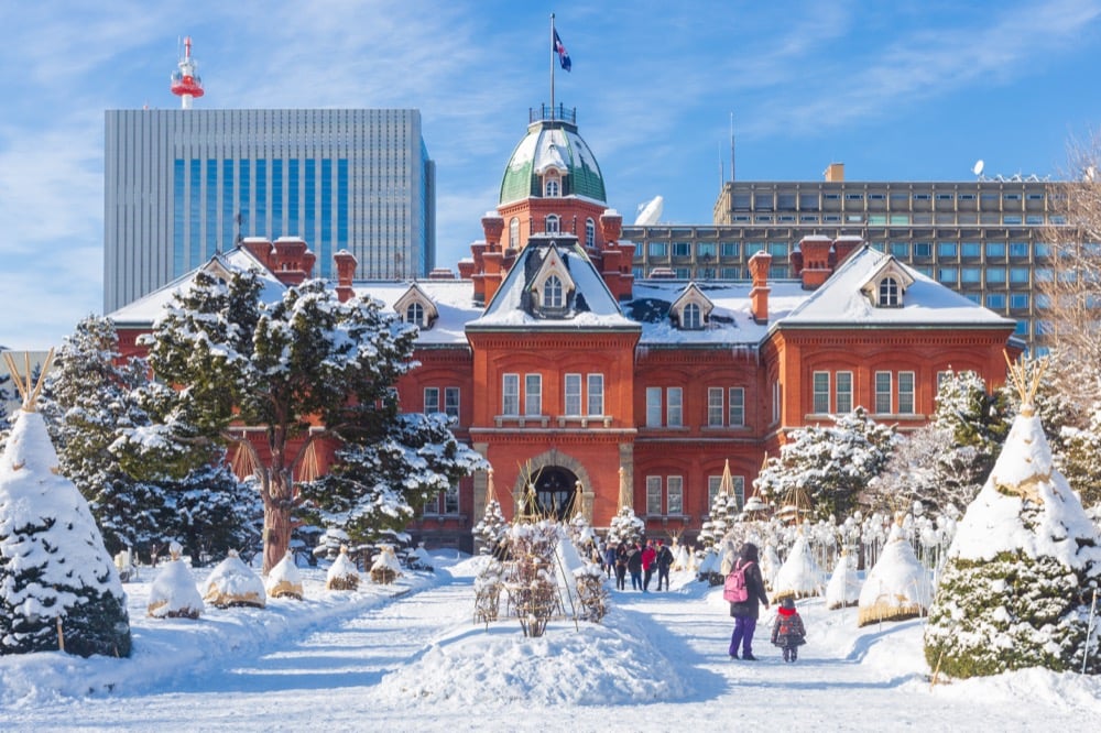 A historic red brick building in snowy park in Hokkaido