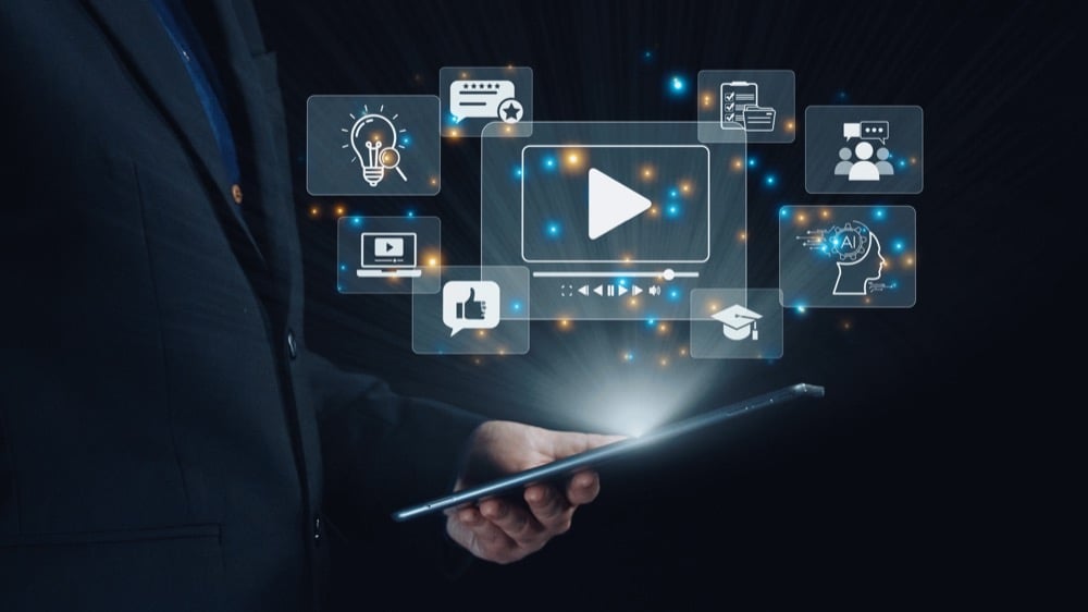 A person holding tablet with floating digital media and AI icons