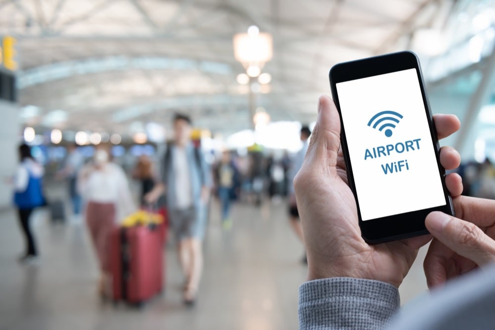 Foreign tourists looking for Wi-Fi at the airport