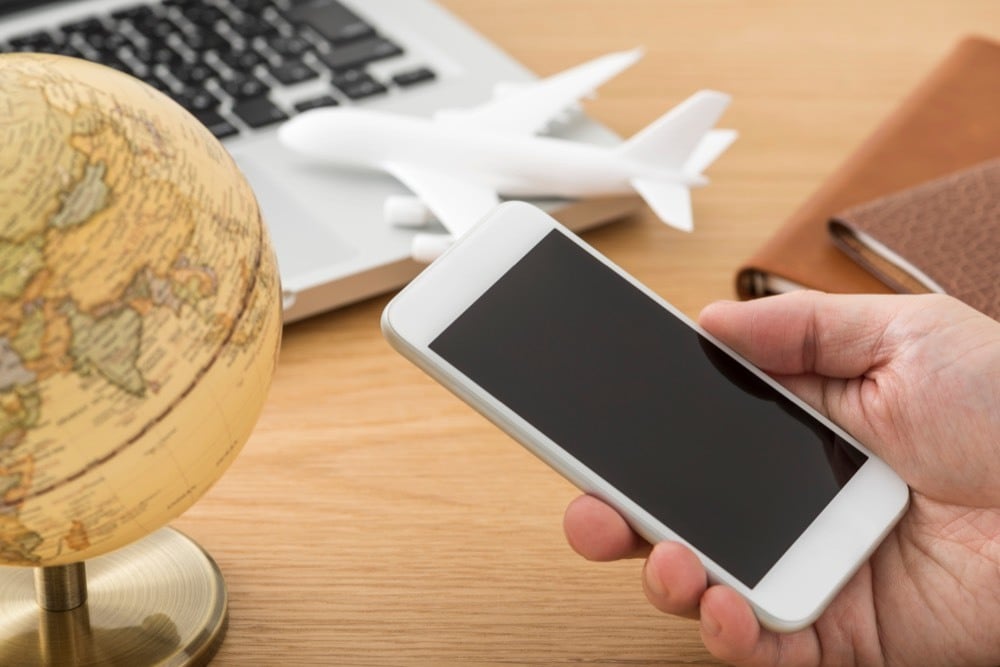 Someone comparing pocket Wi-Fi options on their phone for a trip