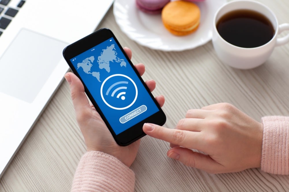 Hand tapping Wi-Fi connect on a phone screen