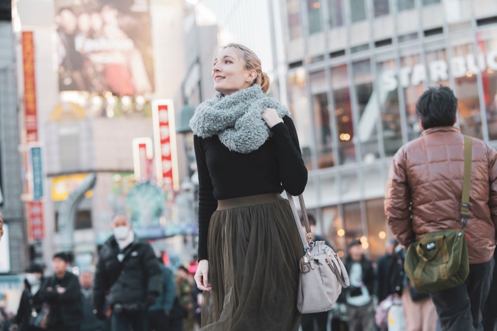 Woman smiling in a busy city street in Japan