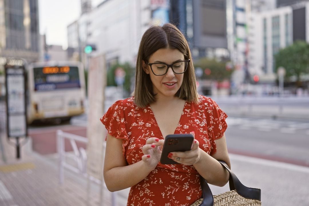 A foreign woman using her smartphone in Japan
