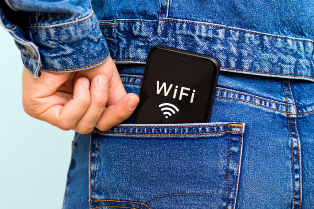 A foreign tourist putting their smartphone with Wi-Fi connected into their pocket