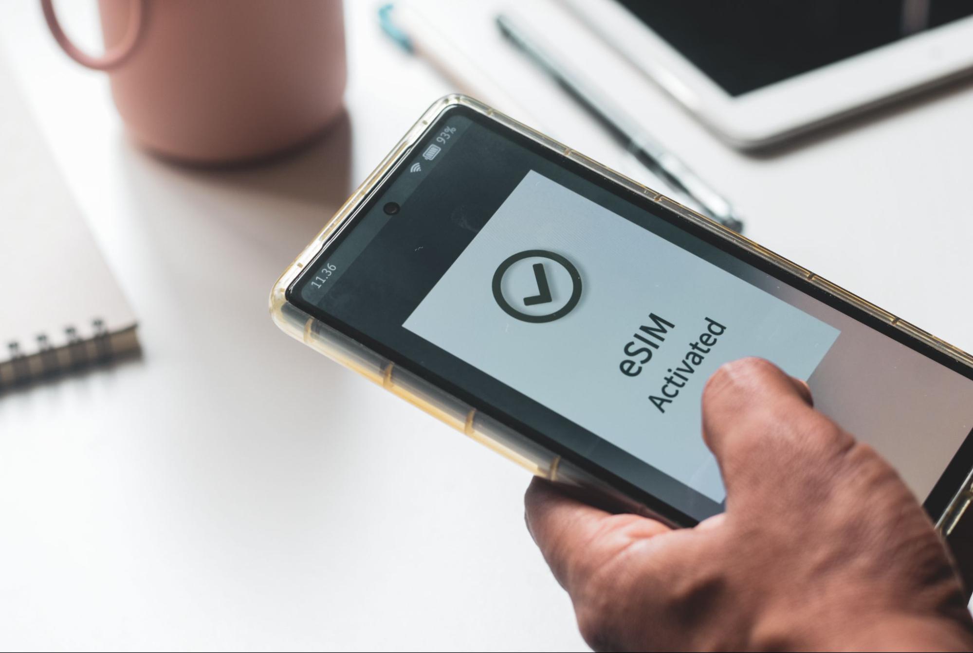 The hand of a man configuring an eSIM