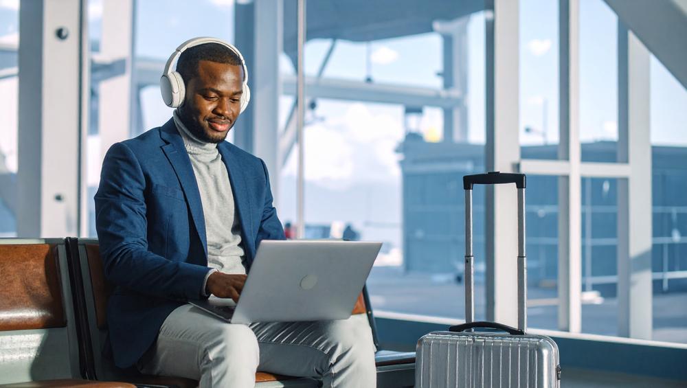 A man working on his laptop at the airport