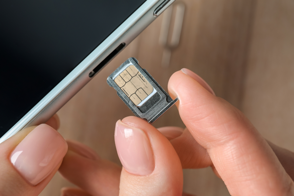 A visitor to Japan about to put a new SIM card into their phone