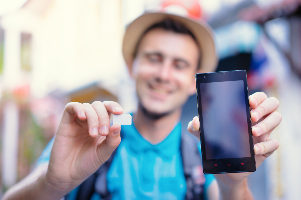 A visitor to Japan about to put a new SIM card into their phone