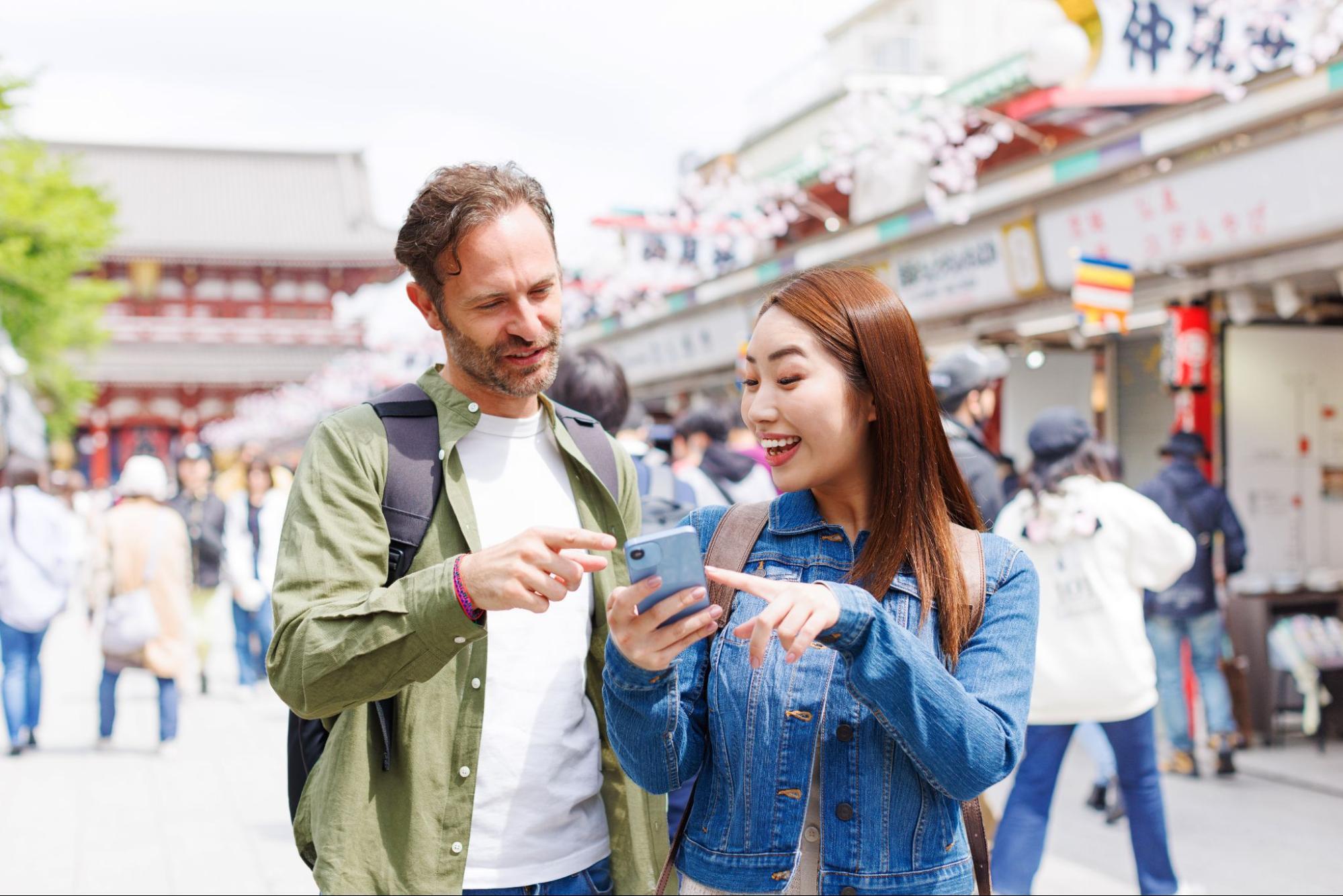 International tourists using smartphones via portable Wi-Fi