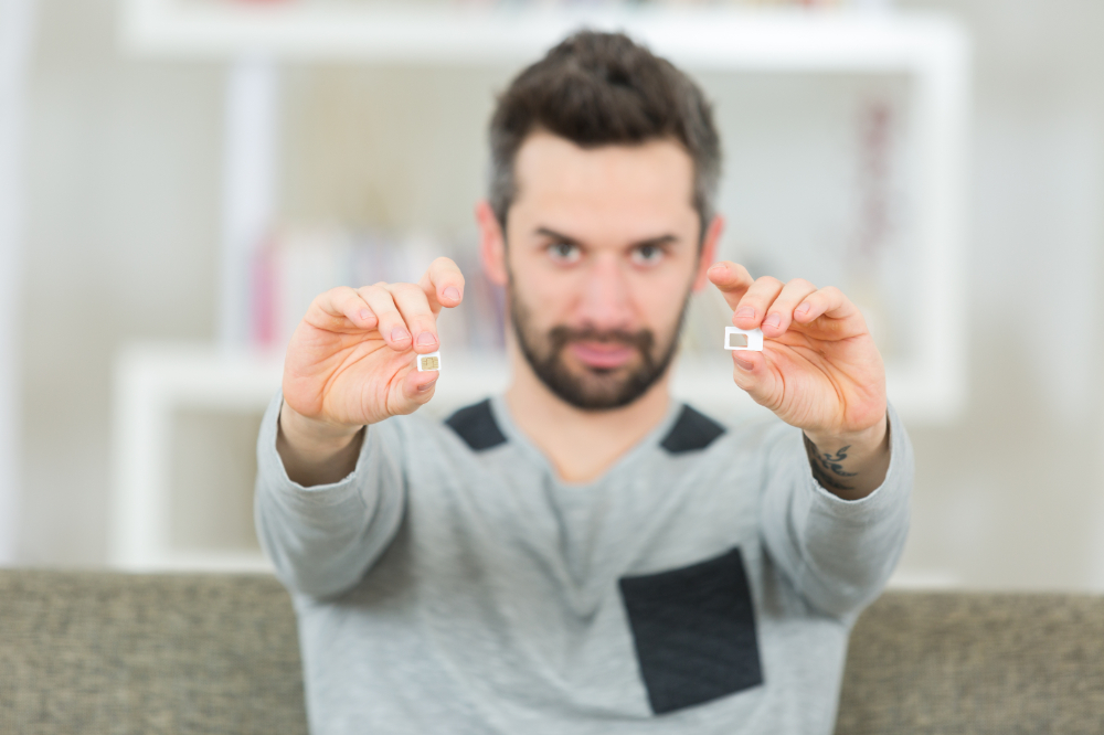 A tourist weighing the pros and cons of a traditional SIM card versus an eSIM