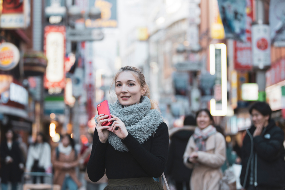 A foreign woman using the phone while traveling in Japan