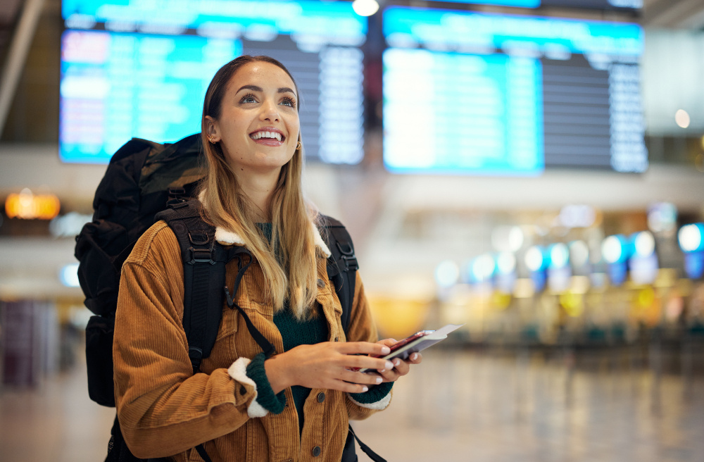 Foreign female tourist uses cell phone at airport