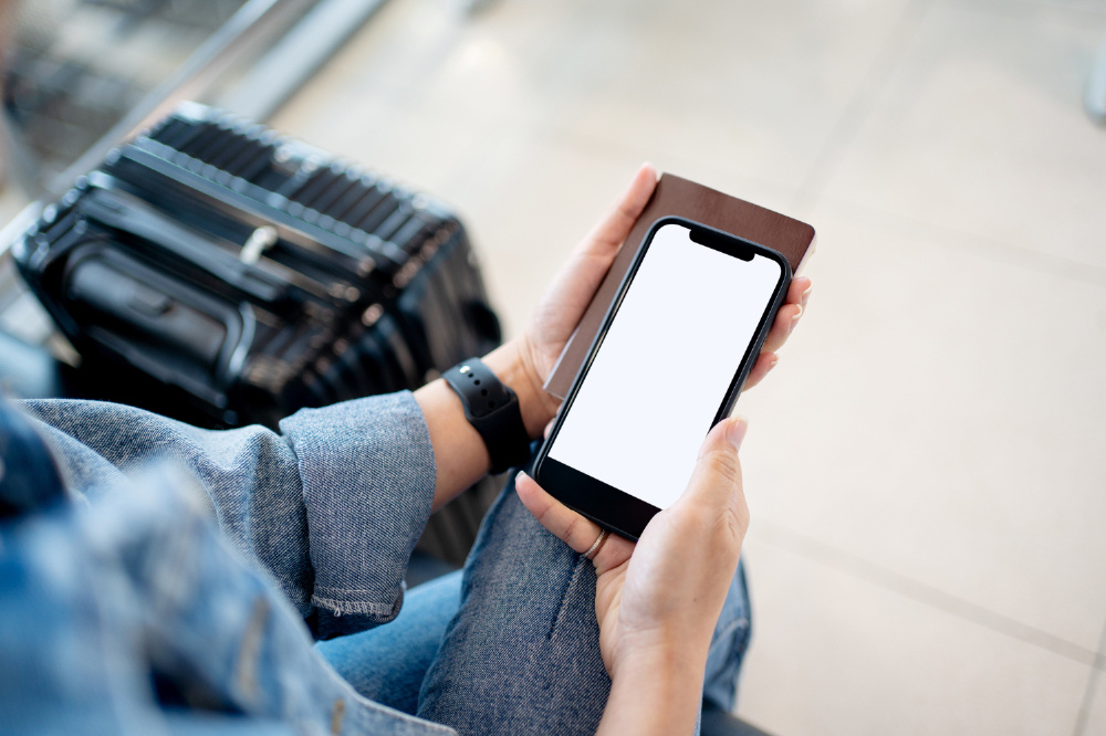 Foreign tourist use cell phones at airport terminal