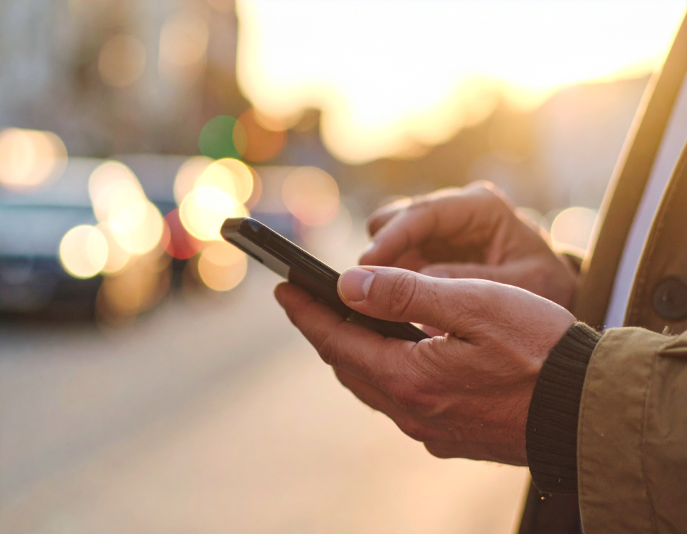 A foreign man using his smartphone in Japan with an eSIM