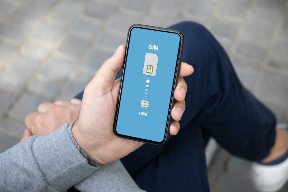 A foreign man switching from a physical SIM card to an eSIM