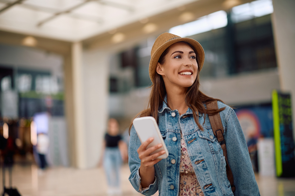 Foreign tourists using cell phone at airport