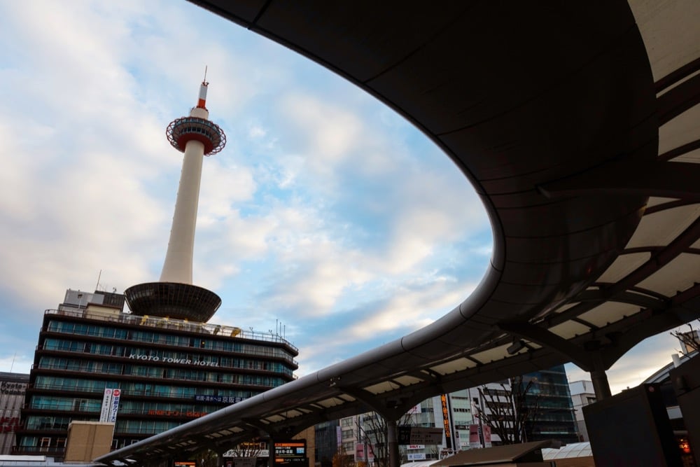 Kyoto Tower and a hotel building framed by modern curved architecture