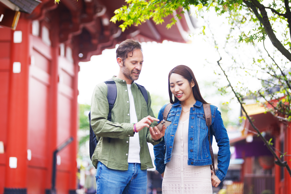 A man and woman using a smartphone in Japan