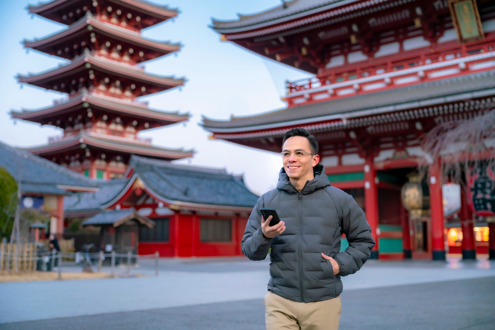 A foreign tourist traveling in Japan using either an eSIM, SIM card, or Pocket WiFi
