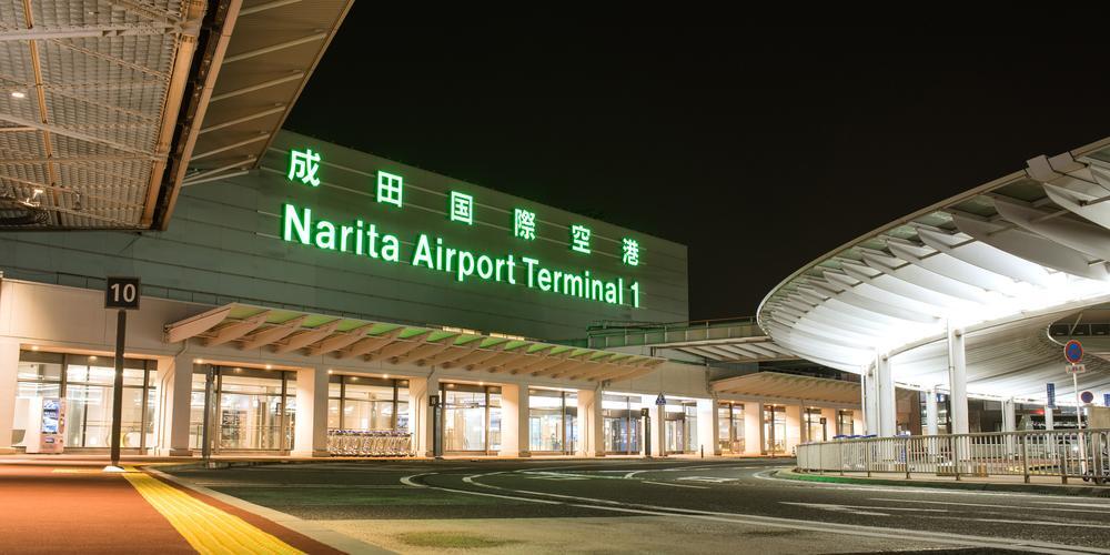 The brightly lit exterior of Narita Airport Terminal 1 at night